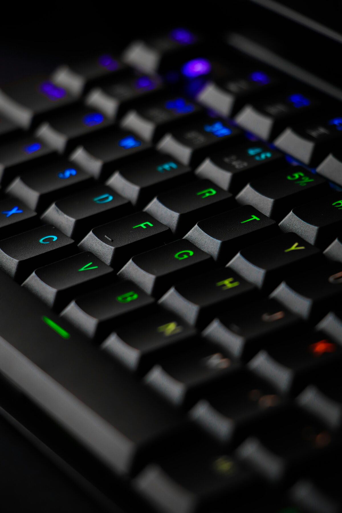 RGB-backlit computer keyboard on a desktop setup